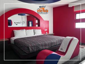 a hotel room with a bed and a red wall at MOTEL SENA in Ensenada