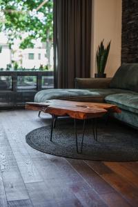 a living room with a coffee table on a rug at Sea Forest loft in Klaipėda