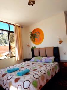 a bedroom with a large bed with blue pillows on it at Suma Uta in Copacabana