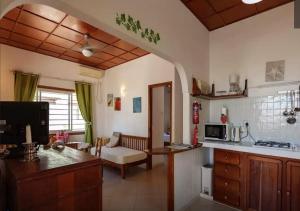 a kitchen and living room with a couch and a table at Maison de Vacanze in Baie Sainte Anne