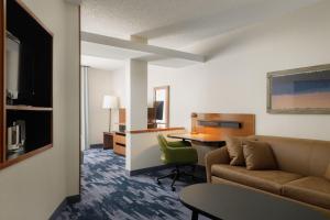 a living room with a couch and a table at Fairfield Inn & Suites Memphis Southaven in Southaven