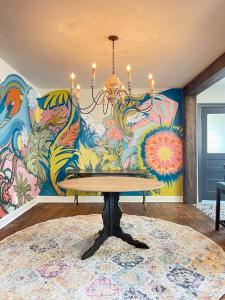 a dining room with a chandelier and a mural at Luxury - Pet Friendly, Farmhouse Bungalow DT Tampa in Tampa