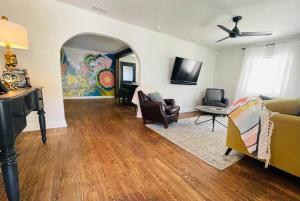 a living room with a couch and chairs and a tv at Luxury - Pet Friendly, Farmhouse Bungalow DT Tampa in Tampa