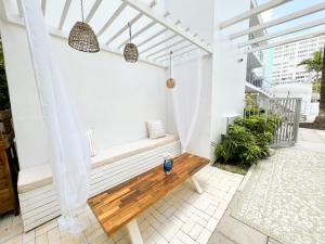 a porch with a wooden bench on a balcony at Aqua Hotel in Fort Lauderdale
