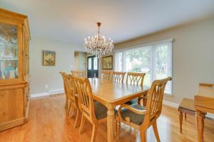 a dining room with a wooden table and chairs at Luxurious Bloomfield Hills Oasis with Pool and Spa! in Bloomfield Hills