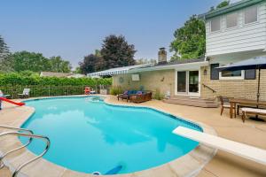 a swimming pool in front of a house at Luxurious Bloomfield Hills Oasis with Pool and Spa! in Bloomfield Hills