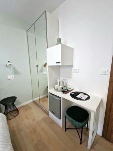 a small white desk with a green chair in a room at Verena's Place Old Town in Zadar