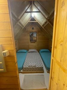 a small room with a bed in the attic at Camping Albania-Secret Village Den in Sarandë