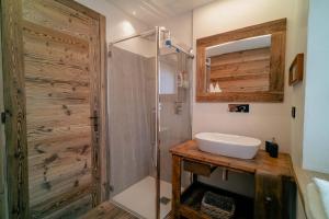 a bathroom with a sink and a shower at Suites Courmayeur - Mont Blanc in Courmayeur