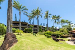 an exterior view of the resort with palm trees at Hanalei Bay Resort in Princeville