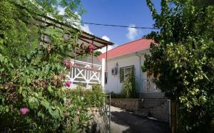 a white house with a red roof at Maison de Vacanze in Baie Sainte Anne