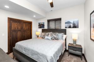 a bedroom with a bed and a wooden door at Angels Landing in Eden