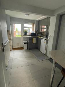 a kitchen with a stove and a counter top at Homestay 1bedroom in family home with small wet room and own entrance in Great Barr