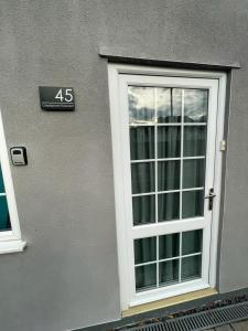 a window on the side of a building with a sign at Homestay 1bedroom in family home with small wet room and own entrance in Great Barr