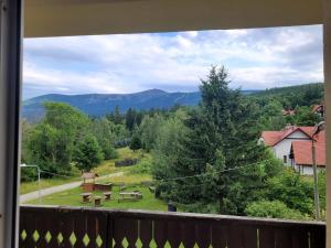 a balcony with a view of a park with picnic tables at Stropnica in Karpacz