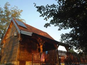 a wooden cabin with a fence in front of it at MIKI Daca in Ljubovija