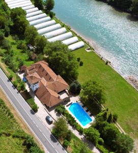 an aerial view of a house next to the water at Heritage Home Ustikolina in Foča