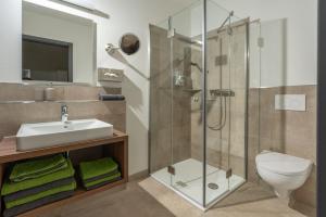 a bathroom with a sink and a shower at Gasthof Hosbein in Heiligenberg +96 photos