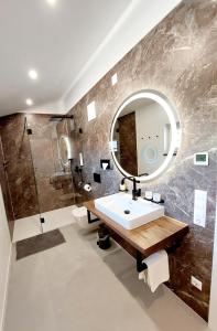 a bathroom with a sink and a mirror at Beim Bergjosl in Kirchbach in Steiermark +24 photos