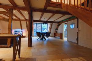 a large room with a table and a grand piano at Apartment Luna in Creglingen