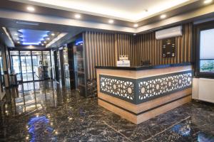 a lobby with a counter in the middle of a building at OF UZUNGÖL APART OTEL in Of