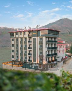 a large apartment building in the middle of a city at OF UZUNGÖL APART OTEL in Of