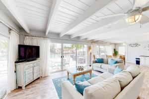 a living room with a couch and a tv at Breezy Keys in Key Colony Beach