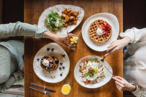 two people sitting at a table with plates of food at The Westin Austin at The Domain in Austin