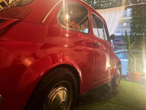 a red car is parked on the grass at via ROMA 100 ROOMS in Enna