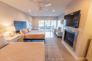 a living room with two beds and a fireplace at Baywood Inn Bed & Breakfast in Los Osos