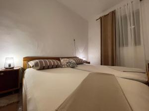 Postel nebo postele na pokoji v ubytování Apartmani Meri