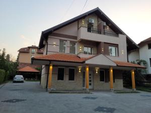 a house with a car parked in front of it at Apartmani Zvezdana in Vrnjačka Banja