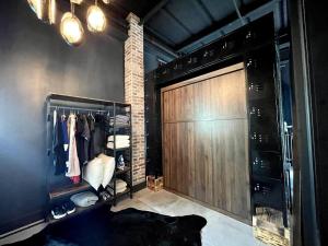 a walk in closet with a large wooden door at Luxury Loft - Downtown Tampa, Ybor, Armature in Tampa