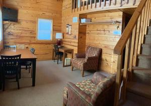 a living room with a table and chairs in a cabin at Trailshead Lodge - Cabin 4 in Lead