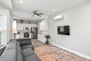 a living room with a couch and a tv at Beautiful Condo Near Boardwalk Beach & Downtown in Ocean City
