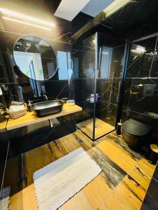 a bathroom with a sink and a mirror at Zoe Rooftop in Netanya