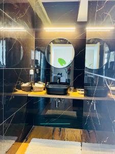 a bathroom with a sink and a mirror at Zoe Rooftop in Netanya