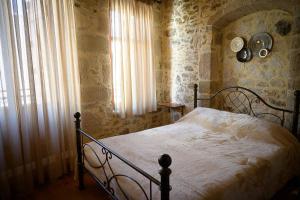 A bed or beds in a room at Traditional Stone Mezonete