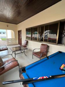 a pool room with a pool table and chairs at Exclusive Holiday Villa with Pool in Accra in Accra