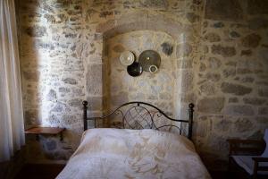 A bed or beds in a room at Traditional Stone Mezonete