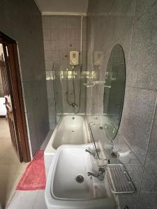 a bathroom with a sink and a mirror at Exclusive Holiday Villa with Pool in Accra in Accra