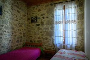 A bed or beds in a room at Traditional Stone Mezonete