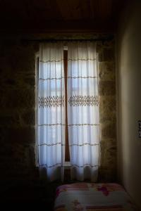A bed or beds in a room at Traditional Stone Mezonete