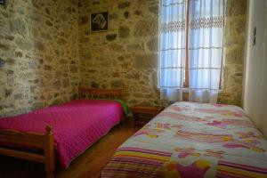 A bed or beds in a room at Traditional Stone Mezonete
