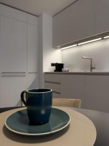 Una taza de café azul sentada en una mesa en una cocina en GARIBALDI13, en Morbegno