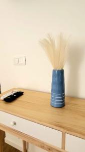 a blue vase sitting on top of a wooden table at MARÈ Terracina Suites in Terracina