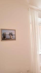 a picture hanging on a white wall with a window at MARÈ Terracina Apartments in Terracina