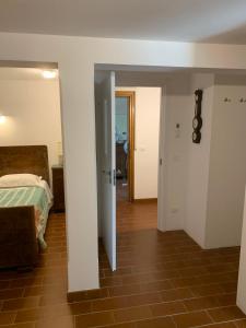 a bedroom with a bed and a hallway with a door at Villa Venezia in Torre di Mosto