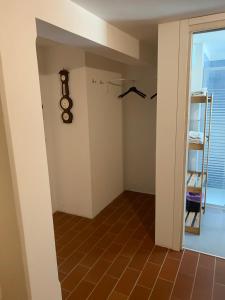 a hallway with a room with a clock on the wall at Villa Venezia in Torre di Mosto