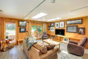 a living room with a couch and a tv at Unique Nordman Retreat 1 Mi to Priest Lake! in Nordman